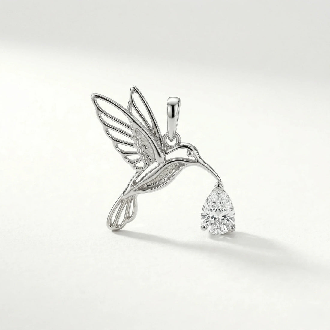 silver colorless gemstone pear hummingbird motif, nature-inspired, outline pendant